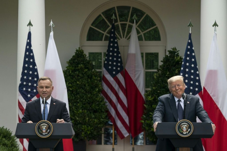Polish President Andrzej Duda speaks as US President Donald Trump looks on during a joint news conference in the Rose Garden of the White House