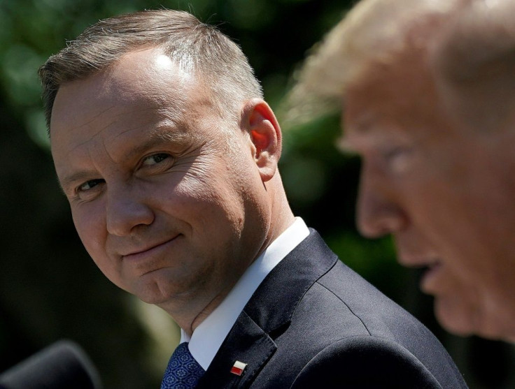 Polish President Andrzej Duda listens as US President Donald Trump speaks during a joint news conference conference in the Rose Garden of the White House