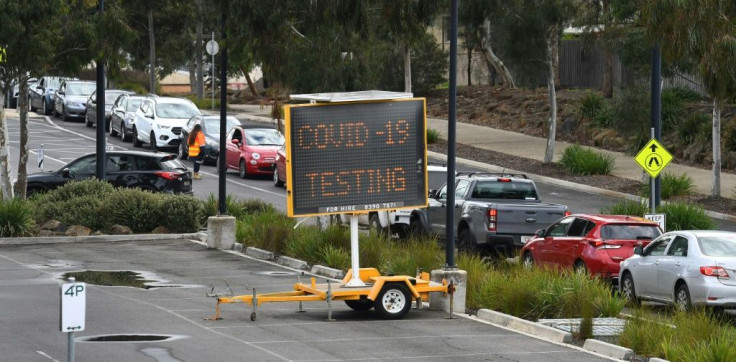 A long queue of cars wait at a drive-through COVID-19 testing site in Melbourne