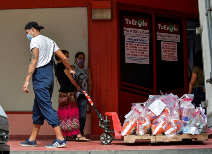 A worker transports online purchases at a pick up center in Havana, on June 17, 2020