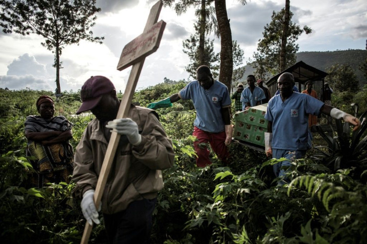 Health workers carry a coffin containing a victim of Ebola in Butembo, eastern DR Congo