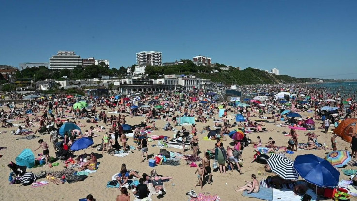Thousands crowd the beach in the English coastal town of Bournemouth to soak up the sun on the hottest day of the year as lockdown measures are slowly eased -- but with officials still warning of another surge in COVID-19 cases