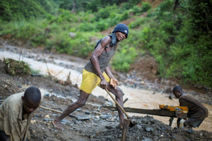 A group mines gold from a riverbed southwest of the city of Bukavu, in the DR Congo in March 2017