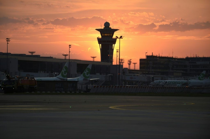 With the control tower looming high, aircraft stand at terminal gates prior to the first flight departing for Portugal on the day Paris-Orly airport reopened.