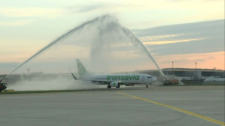 A plane gets a water salute from firefighters as it becomes the first to take off from the Orly airport south of Paris after it had shut down on March 31 amid the coronavirus pandemic.