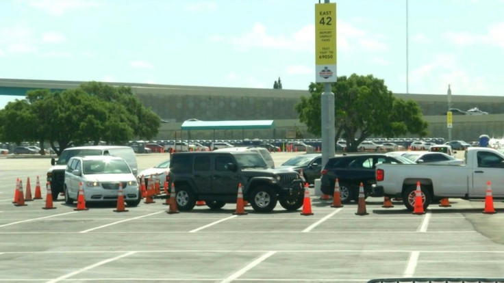 Long line of cars wait at coronavirus drive-through testing site in Miami