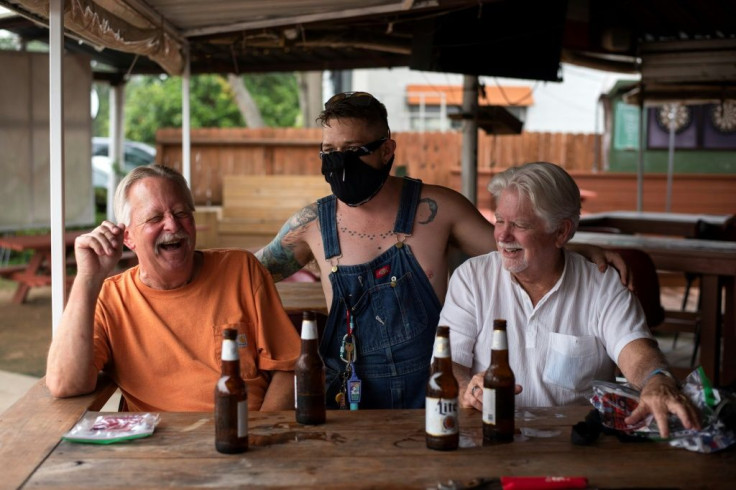 Patrons at the West Alabama Ice House in Houston have beers before Texas Governor Greg Abbott's order that all bars are to be closed amid a surge in coronavirus cases
