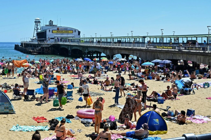 Beachgoers enjoy the sunshine in Bournemouth, southern England -- but the crowded shore raised alarm bells for local officials worried about an uptick in virus cases
