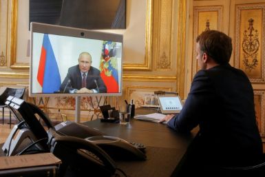 French President Emmanuel Macron talks to Russian President Vladimir Putin during a videoconference on June 26 at the Elysee Palace in Paris
