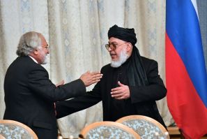 Taliban spokesman Mohammad Abbas Stanikzai (right) greets a participant during the opening of talks with Afghanistan's opposition in Moscow in February 2019