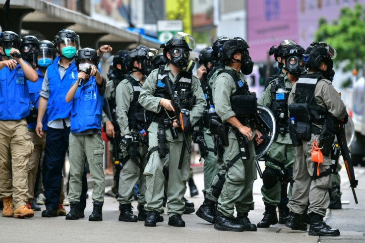 Riot police gather on a road in Hong Kong as protesters take part in a pro-democracy rally against China's proposed new security law in May 2020