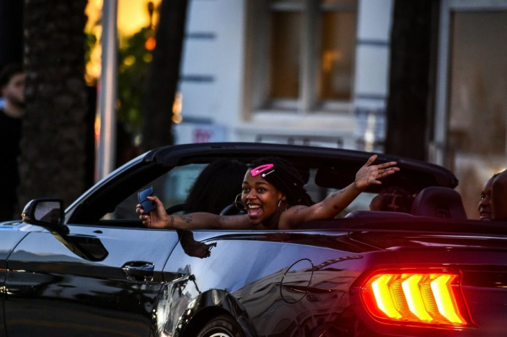 A woman shouts as she drives thru Miami Beach, Florida on June 26, 2020, the day the state recorded nearly 10,000 COVID-19 cases, a record high