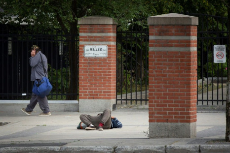 A pedestrian walks past a passed-out drug user on June 25, 2020 in Ottawa, Canada; an emergency government pandemic payment has been used by some addicts to buy drugs, and overdoses have surged