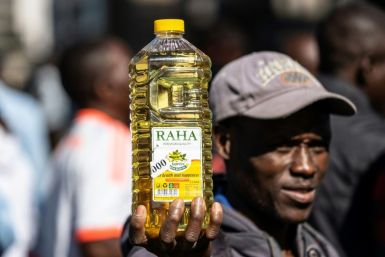 Inflation anger: A protester holds a bottle of cooking oil during a demonstration in Harare last August over the cost of food