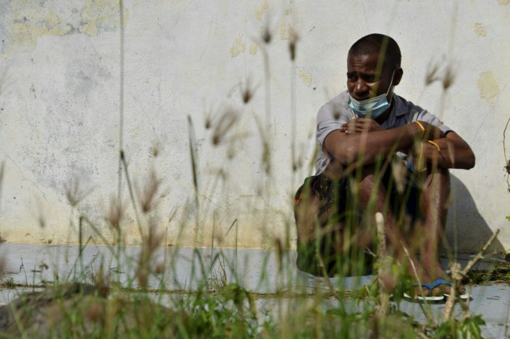 A Rohingya man sits outside the immigration detention centre in Lhokseumawe, Indonesia