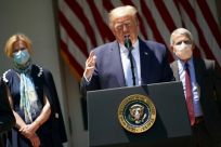 US President Donald Trump is seen flanked by top White House coronavirus task force officials Deborah Birx (L) and Anthony Fauci (R), on May 15, 2020