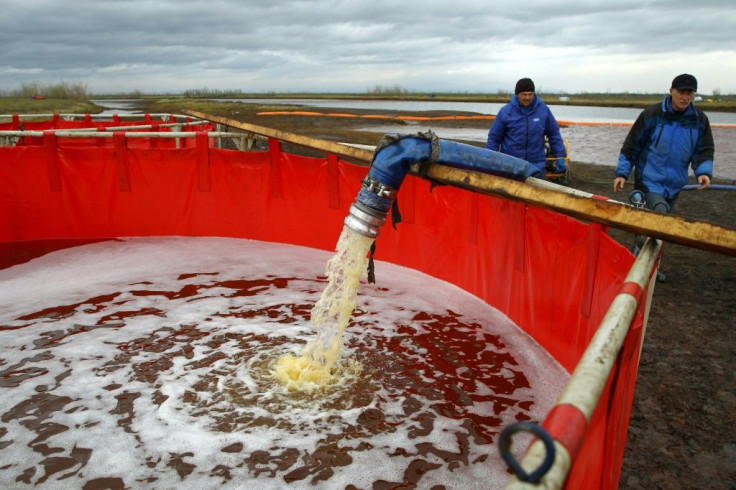 Employees of Russia's state-owned oil pipeline monopoly Transneft take part in the clean-up operation after the massive fuel spill in the Ambarnaya River last month
