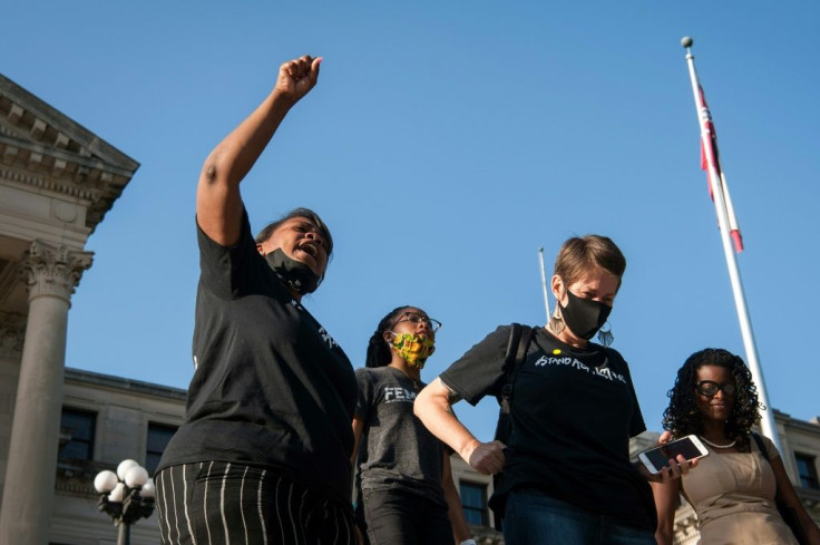 Protesters celebrate the state Mississippi legislature's historic vote to change the state flag at the state capitol building in Jackson, Mississippi on June 28, 2020
