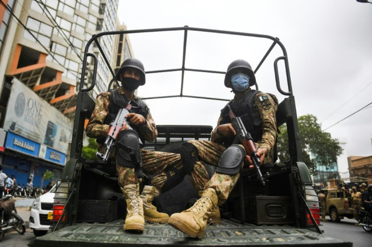 Paramilitary soldiers patrol near the Pakistan Stock Exchange building in Karachi following an attack by Baloch separatists