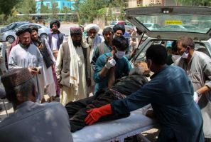 A  man injured in an explosion at a cattle market is brought to in Lashkar Gah, Helmand province