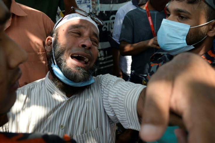 A relative of a victim of the capsized ferry mourns as rescue workers unload bodies in Dhaka, Bangladesh