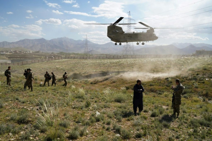 A US military Chinook helicopter lands in June 2019 outside the governor's palace in Wardak province in Afghanistan, where reports say Russia has paid Taliban-linked militants bounties to target US forces