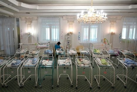 A nurse cares for newborn babies at Kiev's Venice hotel -- dozens born to surrogate mothers were stranded in Ukraine as their foreign parents were unable to collect them for weeks owing to coronavirus border closures