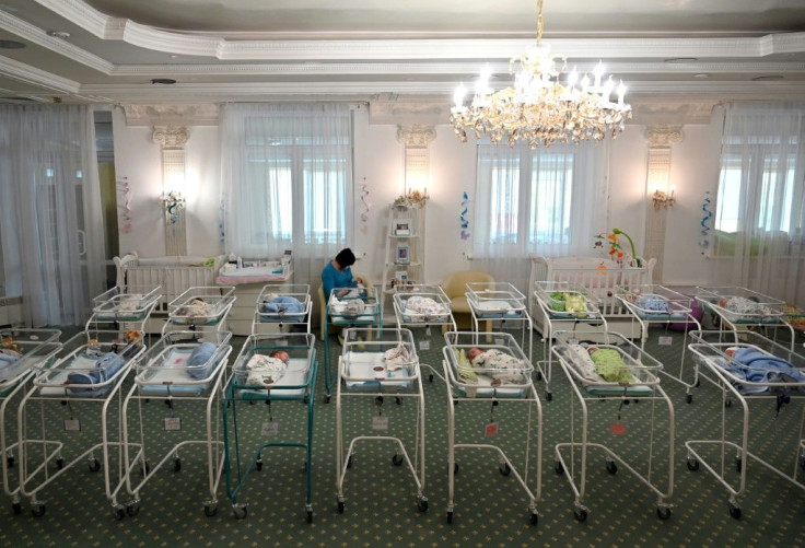 A nurse cares for newborn babies at Kiev's Venice hotel -- dozens born to surrogate mothers were stranded in Ukraine as their foreign parents were unable to collect them for weeks owing to coronavirus border closures