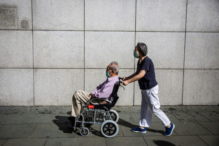 Lau Man-shing, pictured with his caretaker, said he felt Hong Kongers had been left with little choice but to resort to violent confrontations