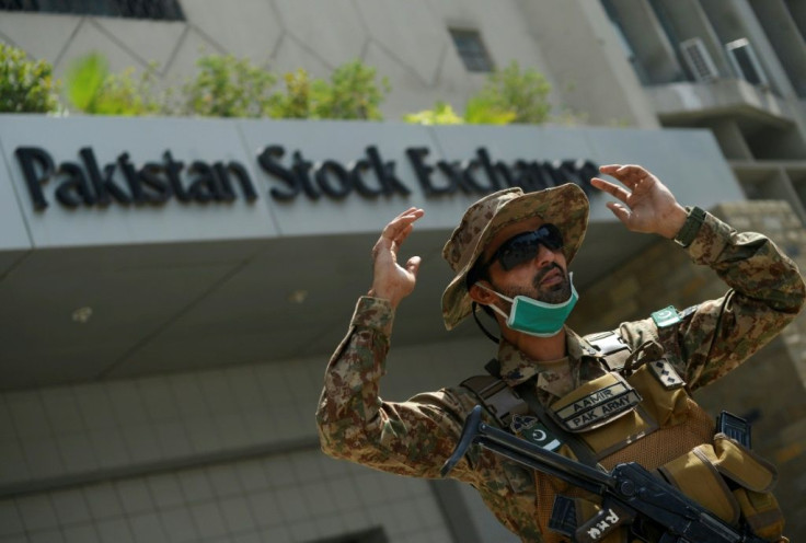 A paramilitary soldier gestures while standing guard outside the Pakistan Stock Exchange after gunmen attacked the building