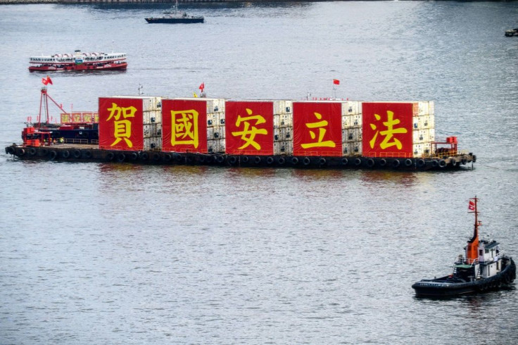 A barge with banners marking the passing of the national security law floats in Victoria Harbour on the 23rd anniversary of Hong Kongâs handover from Britain to China
