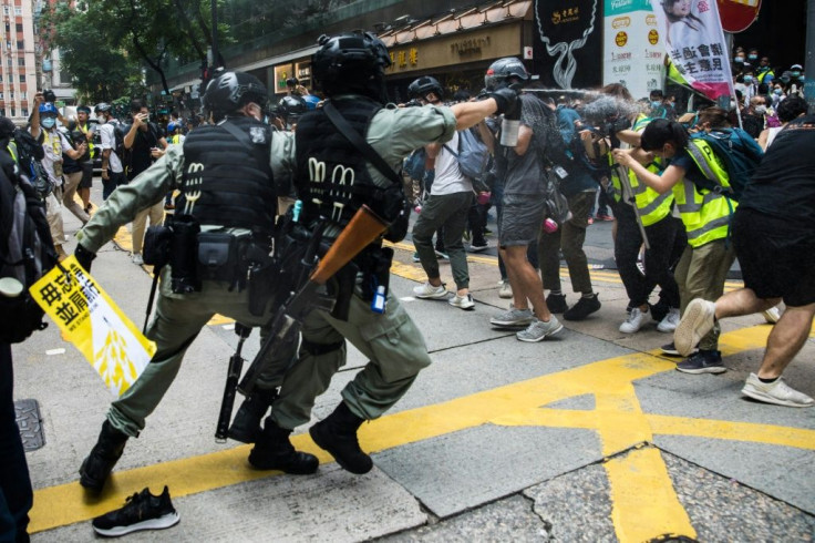 Riot police used pepper spray and made arrests as protesters defied a ban to gather in the popular Causeway Bay shopping district