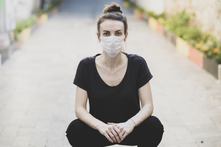 woman coughs in bartender's face after being called out for not wearing mask