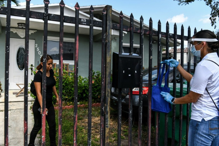 Government works are handing out free masks and protective advice in Miami amid a surge in cases in Florida