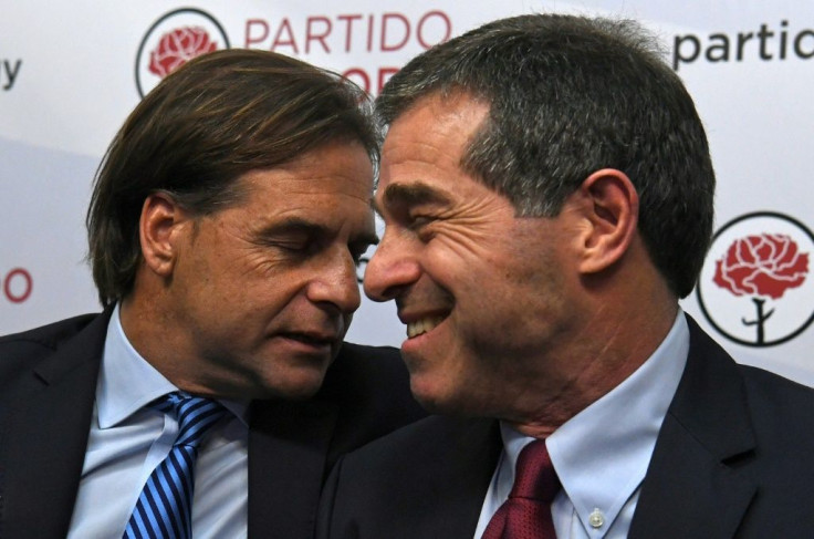 Uruguay's Foreign Minister Ernesto Talvi, who announced his resignation on Wednesday, is pictured (R) in a 2019 meeting with then presidential candidate Luis Lacalle Pou