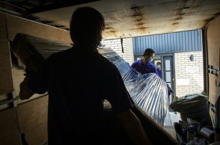 Movers carry Sheila Dassin's belongings into her new abode on July 1 in the Montreal suburb of Laval