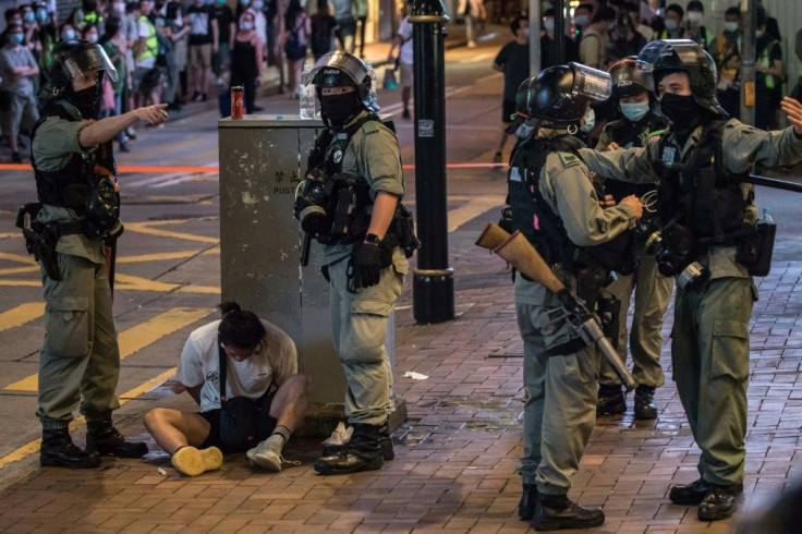 Riot police detain a man after they cleared protesters taking part in a rally against a new national security law in Hong Kong