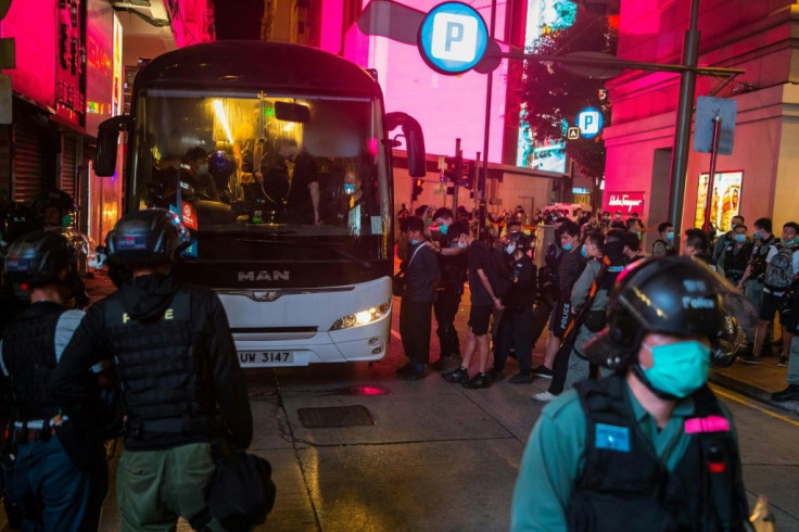 Police detain people on a bus after they clear protesters taking part in a rally against a new national security law in Hong Kong on July 1, 2020