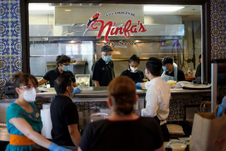 Staff at The Original Ninfa's restaurant in Houston, Texas, seen wearing gloves and masks, on May 1, 2020