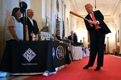 US President Donald Trump takes a swing with a bat from Texas Timber at a Spirit of America event at the White House to showcase small businesses -- he insists the US economy is "roaring back" from the coronavirus crisis