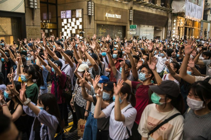 Hong Kong protesters rally against a sweeping new national security law that has prompted some Western nations to offer those from the city refuge