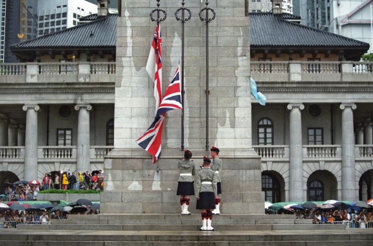 Three British soldiers lower the Union Jack flag for the last time at the Cenotaph monument in the Central district of Hong Kong, 30 June 1997, just hours prior to the end of some 156 years of British colonial rule