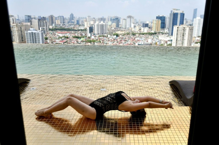 The hotel's gold-plated infinity pool overlooks downtown Hanoi