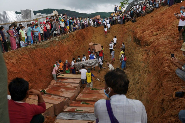 A digger sealed the grave with earth, with many victims yet to be identified