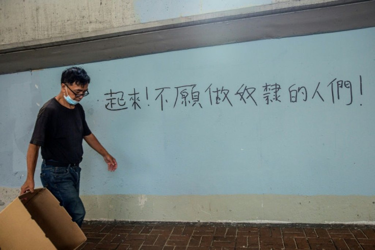 In the busy shopping district of Causeway Bay, one of the main pro-democracy protest spots last year, newly daubed graffiti declares: "Arise, ye who refuse to be slaves" -- the first line of China's national anthem