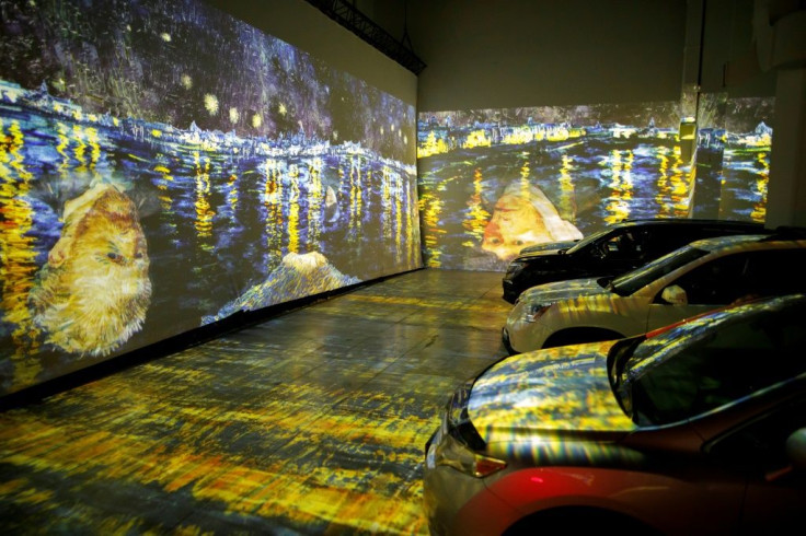 People sit in their cars to experience a drive-in immersive Vincent Van Gogh art exhibit in Toronto, Ontario, Canada on July 3, 2020; amid the coronavirus pandemic, many events are rethinking their programming and innovating for safety's sake