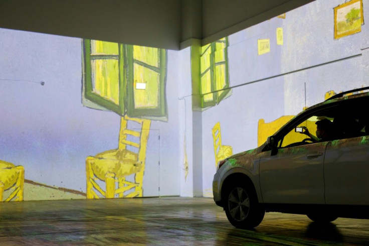 People take photos from their car as they experience a drive-in immersive Vincent Van Gogh art exhibit in Toronto, Ontario, Canada, on July 3, 2020.Amid the coronavirus pandemic, many events are having to rethink their programming and innovate in order to