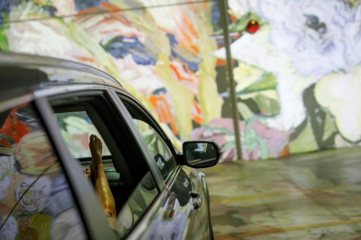 People sit in their cars as they experience a drive-in immersive Vincent Van Gogh art exhibit in Toronto, Ontario, Canada, on July 3, 2020. Amid the coronavirus pandemic, many events are having to rethink their programming and innovate in order to comply 
