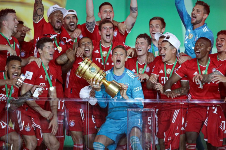 Bayern Munich goalkeeper Manuel Neuer lifts the German Cup trophy after Saturday's 4-2 win over Bayer Leverkuen on Saturday in Berlin.