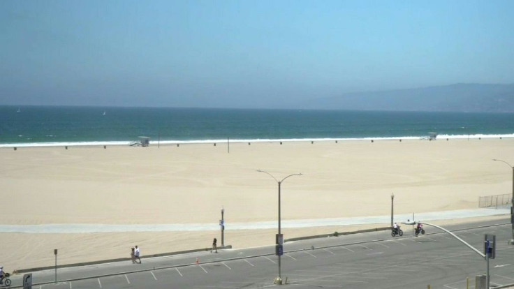 While some people are seen walking around 3rd Street Promenade, Santa Monica State Beach and the Pier lie empty on the July 4th holiday amid growing concerns over the spread of the coronavirus in California